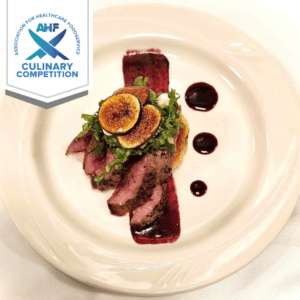 Pan-seared venison, with a blackberry infused bordelaise sauce, over a fennel/mirepoix cowpea cake, peach vinaigrette dressed dandelion greens, with honeyed goat cheese and candied figs.